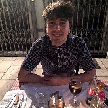 Sam sitting down for a meal.
