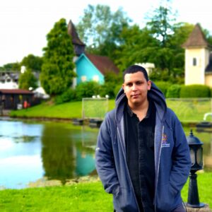 Man outdoors in front of a body of water