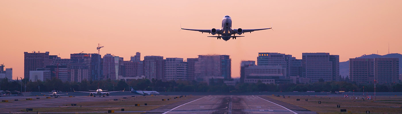 Airliner taking off at sunrise