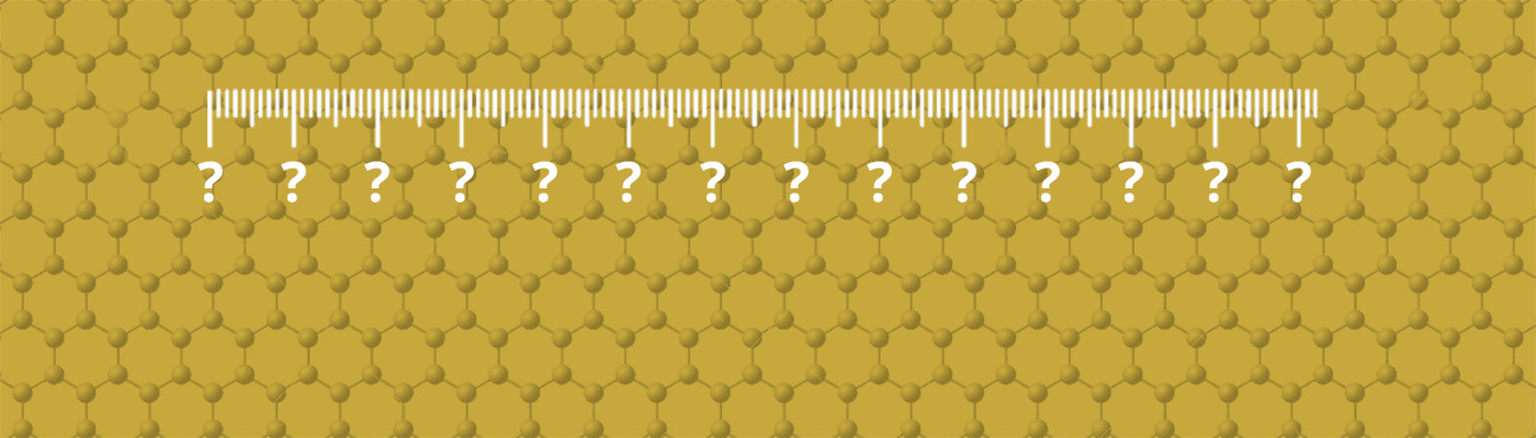 Ruler with question marks on a gold-coloured graphene sheet
