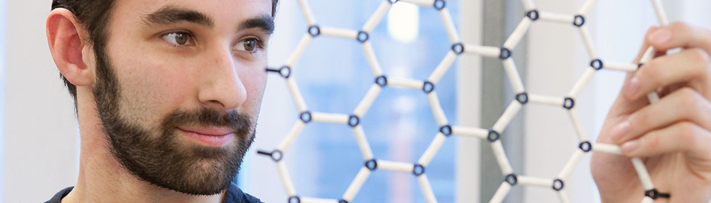 CDT student looking at honeycomb lattice of graphene