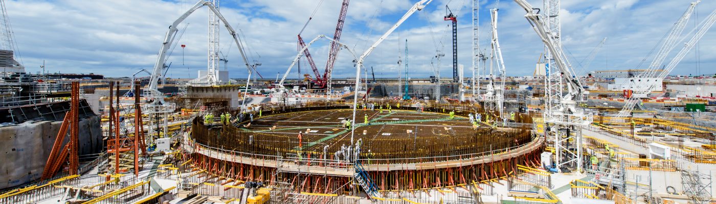 Powerplant construction site surrounded by industrial cranes