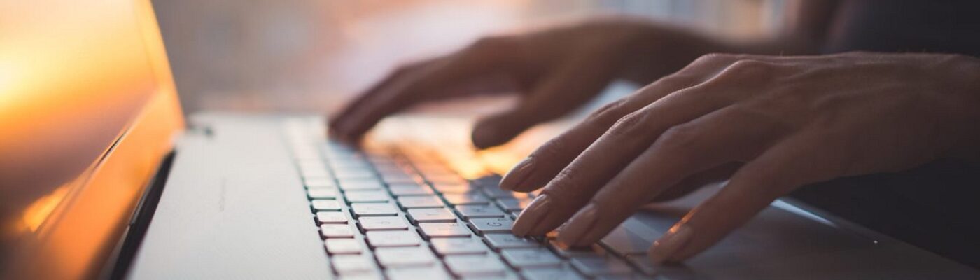 Hands typing on a keyboard
