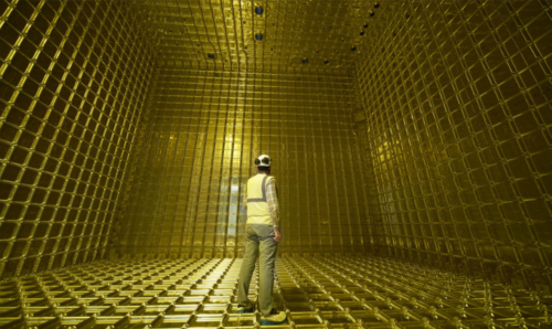 Man in hi-vis and helmet inside a golden chamber