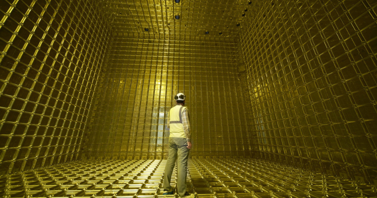 Man in hi-vis and helmet inside a golden chamber