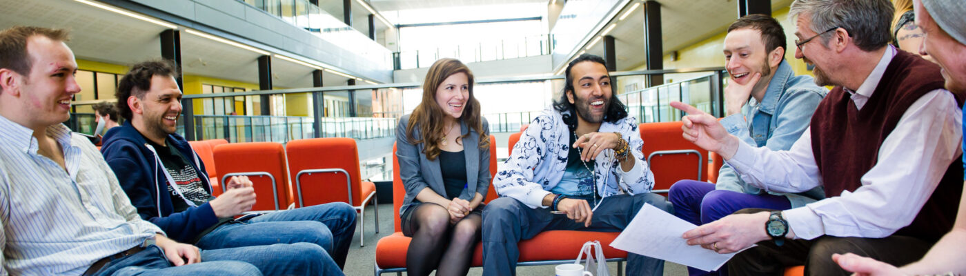 Group of people sitting round a low coffee table