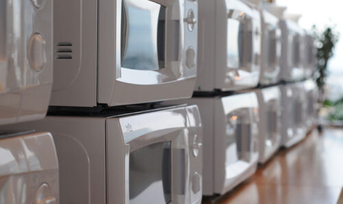 Twelve microwave ovens on top of each other in two rows of sic
