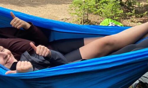 Ezri in a hammock in the Rockies with project partner Eleanor.