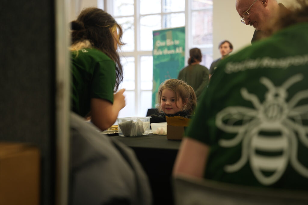 A student volunteer chats with a visitor at Green Together.