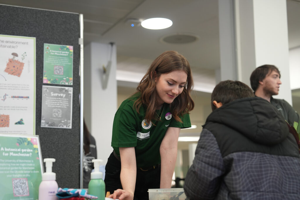 A student volunteer chats with a visitor at Green Together.