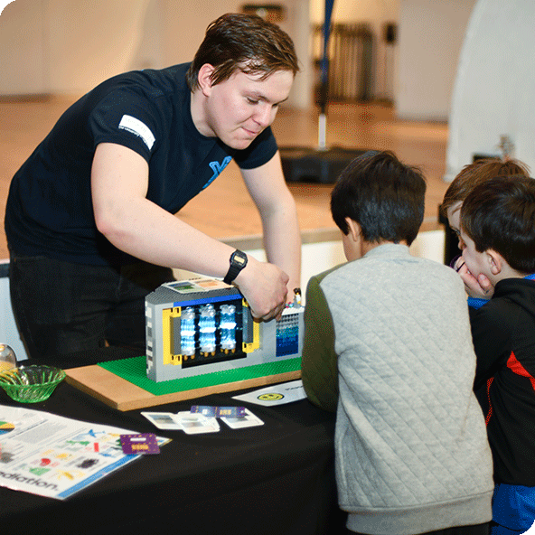 Kids watching a demonstration of a nuclear reactor