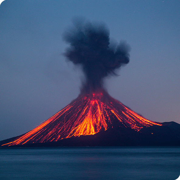 A volcano erupting with lava spilling down the sides