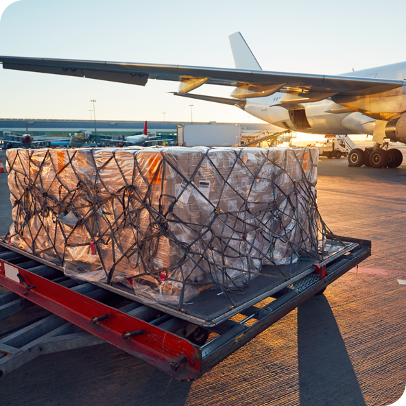 Large cargo ready to be loaded onto a plane in the background